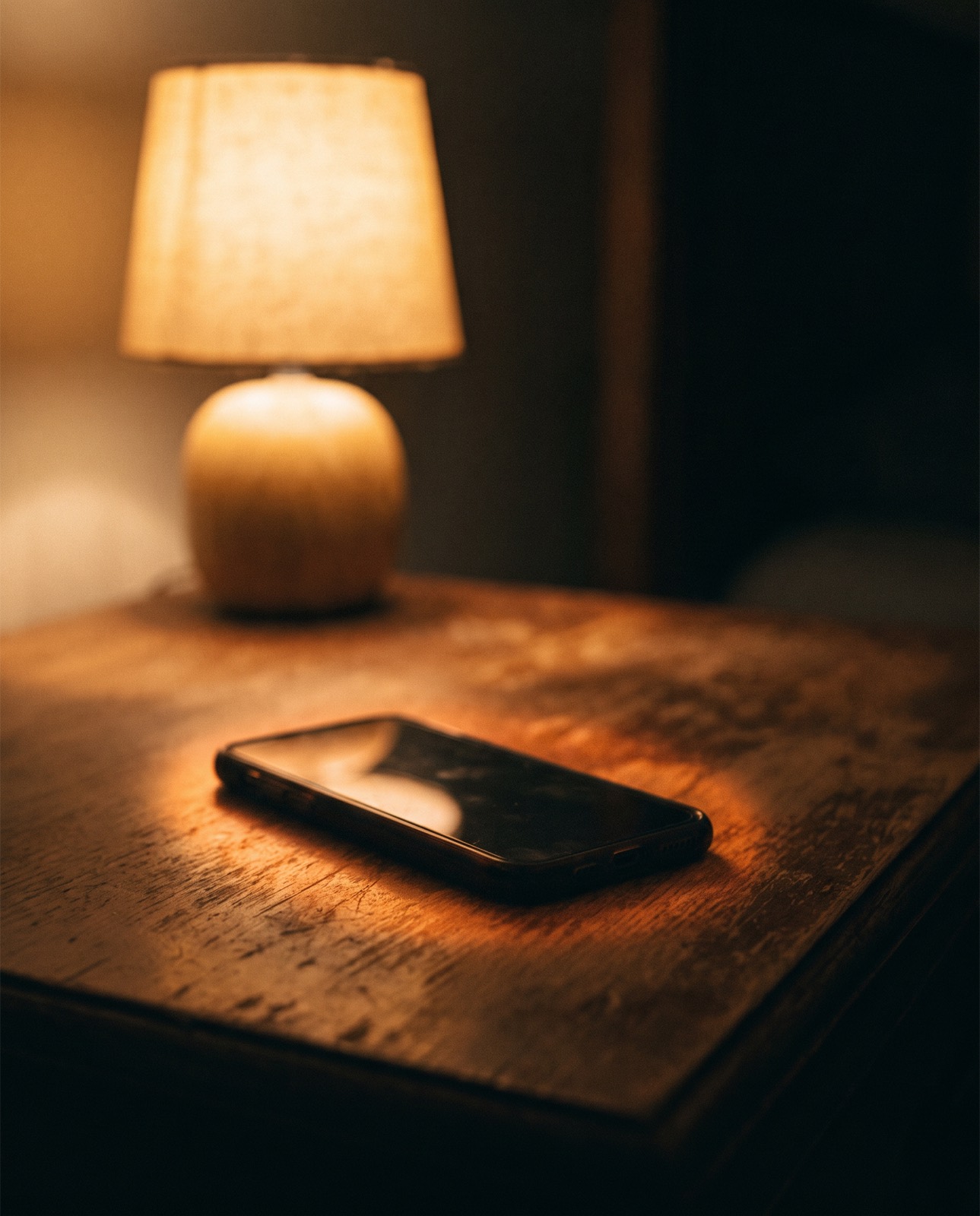 A phone face down on a table at night
